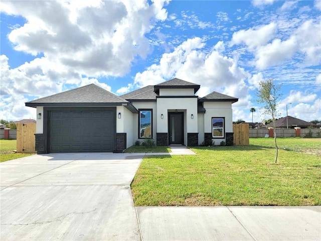 2900 E Palo Blanco St, Hidalgo, TX 78557 - prairie-style house featuring stucco siding, stone siding, an attached garage, concrete driveway, and roof with shingles