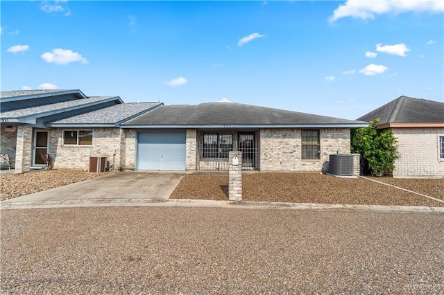 1923 Stadler Dr, Mission, TX 78572 - ranch-style house featuring driveway, a garage, central AC unit, and roof with shingles