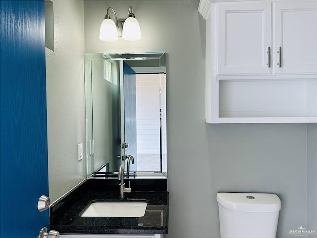 bathroom with vanity and toilet