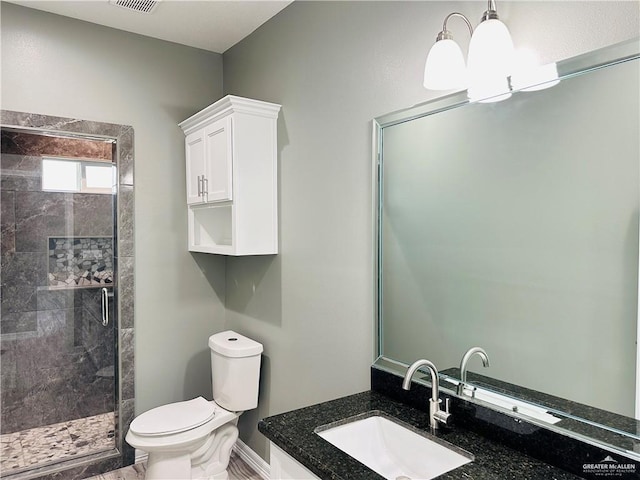 bathroom with a stall shower, visible vents, toilet, an inviting chandelier, and vanity