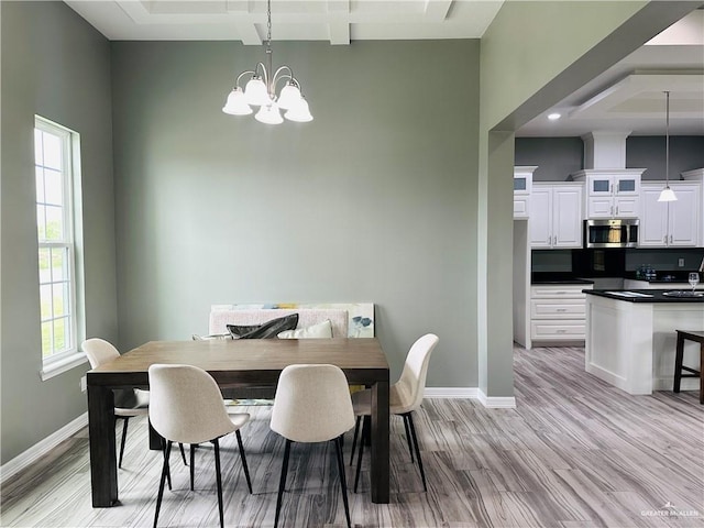 dining room featuring a chandelier, light wood-style floors, beam ceiling, and baseboards