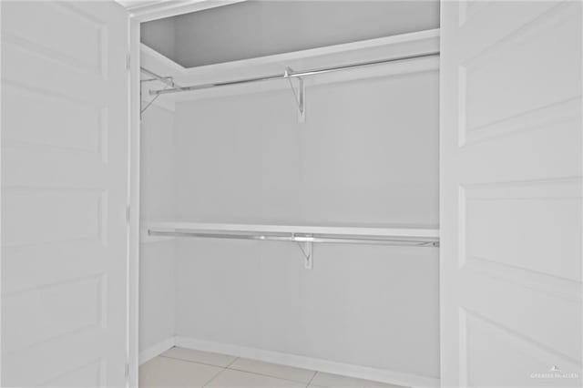 walk in closet featuring light tile patterned flooring