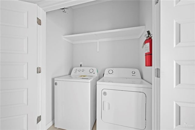 clothes washing area featuring washer and clothes dryer