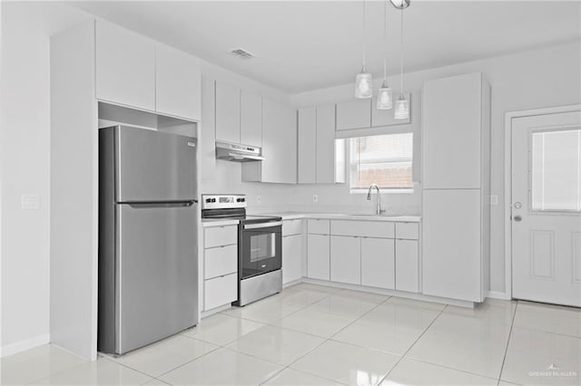 kitchen with light tile patterned flooring, sink, decorative light fixtures, appliances with stainless steel finishes, and white cabinets