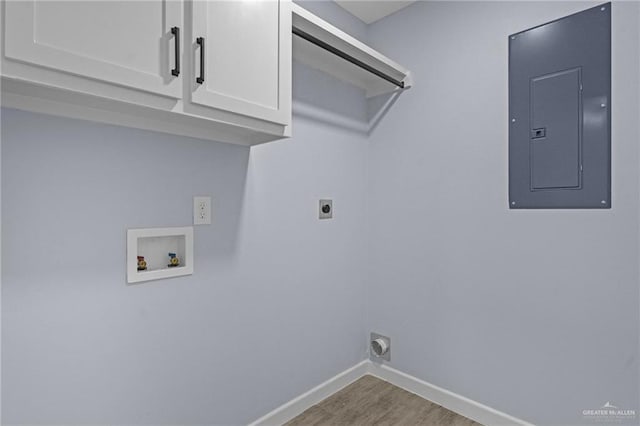 clothes washing area featuring hookup for a washing machine, electric panel, cabinets, light hardwood / wood-style floors, and hookup for an electric dryer