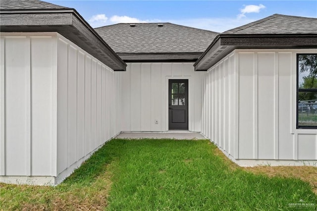 doorway to property featuring a lawn