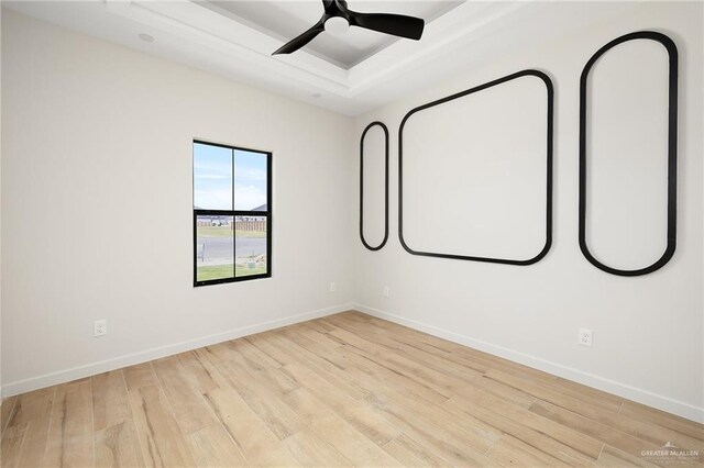 2717 E Versace Dr, Edinburg, TX 78542 - spare room with a raised ceiling, wood finished floors, and baseboards