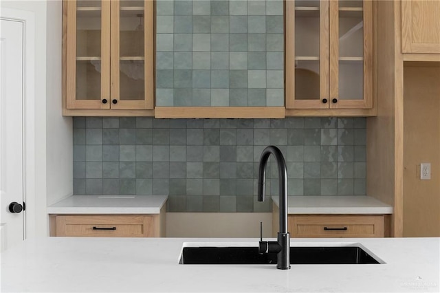 2717 E Versace Dr, Edinburg, TX 78542 - kitchen with a sink, backsplash, and glass insert cabinets