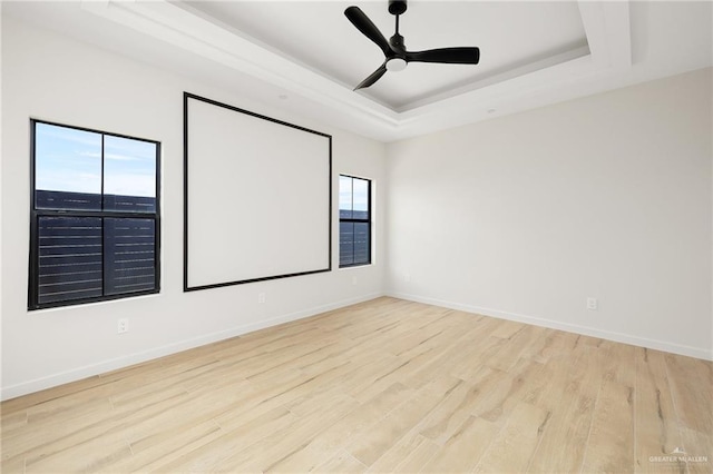 2717 E Versace Dr, Edinburg, TX 78542 - unfurnished room featuring a raised ceiling, wood finished floors, baseboards, and a ceiling fan
