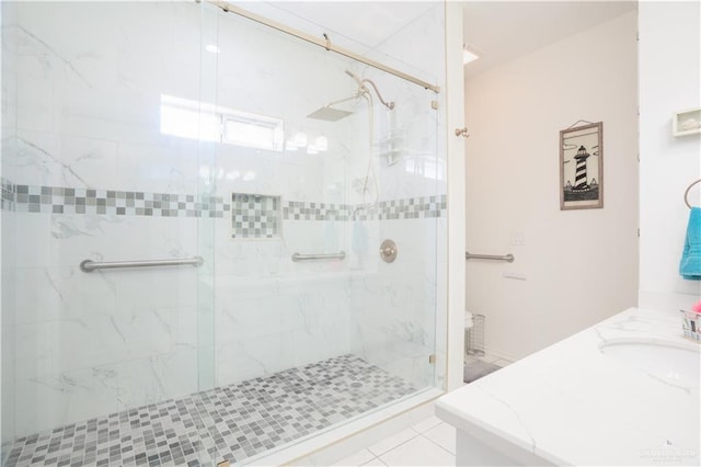 full bathroom with a stall shower, tile patterned flooring, and vanity