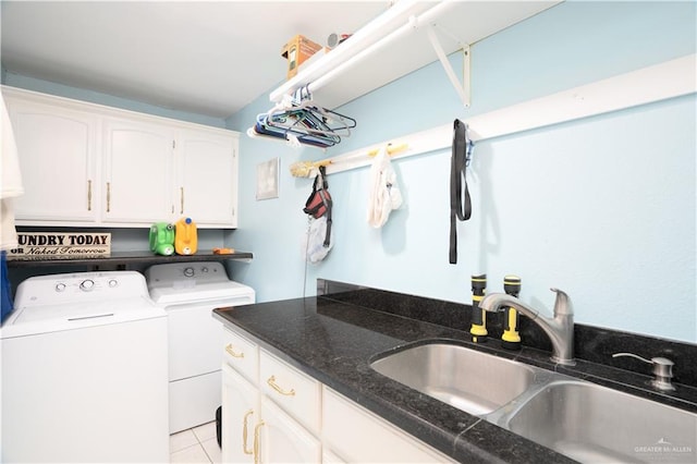 washroom with cabinet space, light tile patterned floors, a sink, and independent washer and dryer