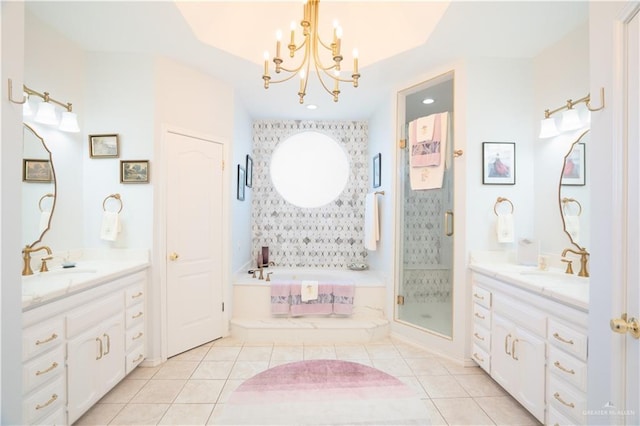 full bath featuring two vanities, a stall shower, tile patterned flooring, and a sink