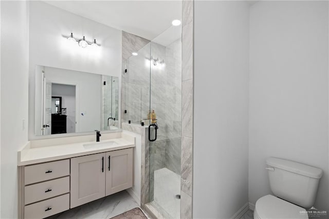 bathroom with toilet, marble finish floor, a stall shower, and vanity