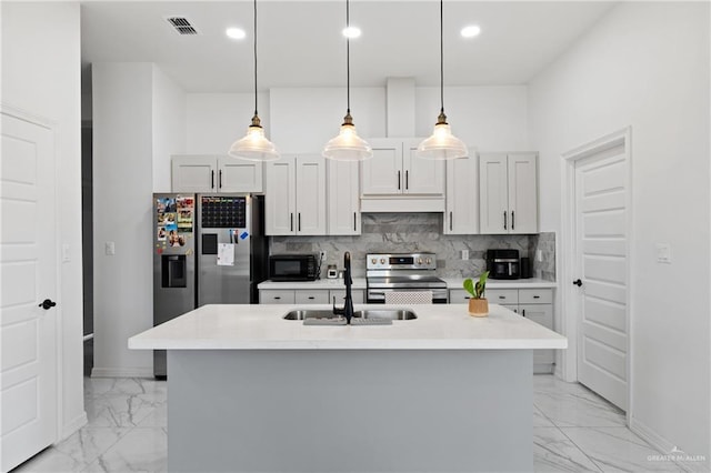 kitchen featuring stainless steel appliances, marble finish floor, a sink, and decorative backsplash