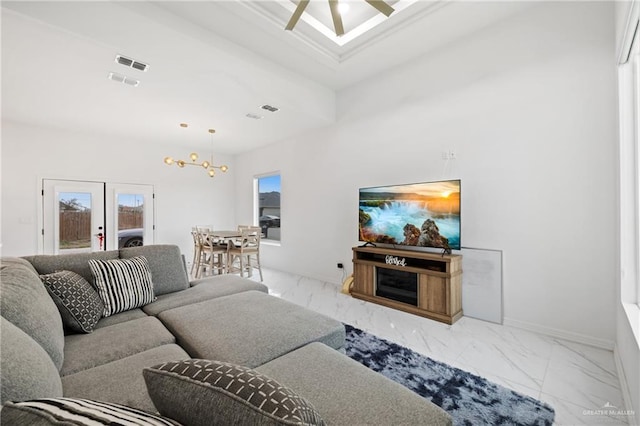 living room featuring marble finish floor, visible vents, ceiling fan, and baseboards