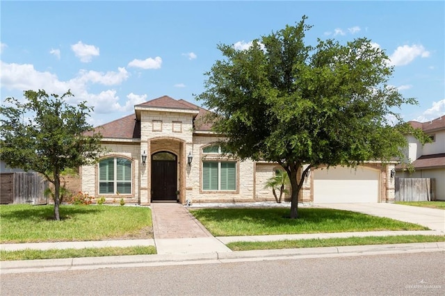13410 N 36th Ln, Edinburg, TX 78541 - view of front facade with driveway, an attached garage, and stone siding