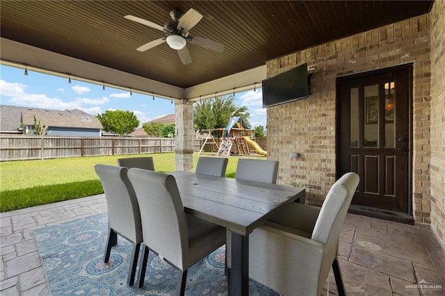 13410 N 36th Ln, Edinburg, TX 78541 - fenced backyard with a patio area, outdoor dining space, a ceiling fan, and a playground