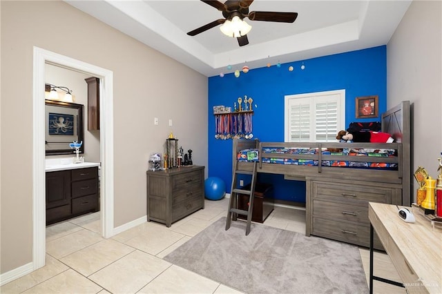 13410 N 36th Ln, Edinburg, TX 78541 - bedroom with a tray ceiling, a desk, ensuite bath, and light tile patterned floors