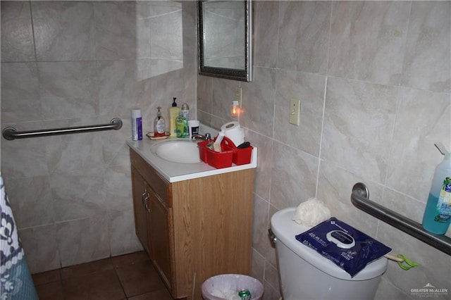 bathroom featuring vanity, toilet, and tile walls