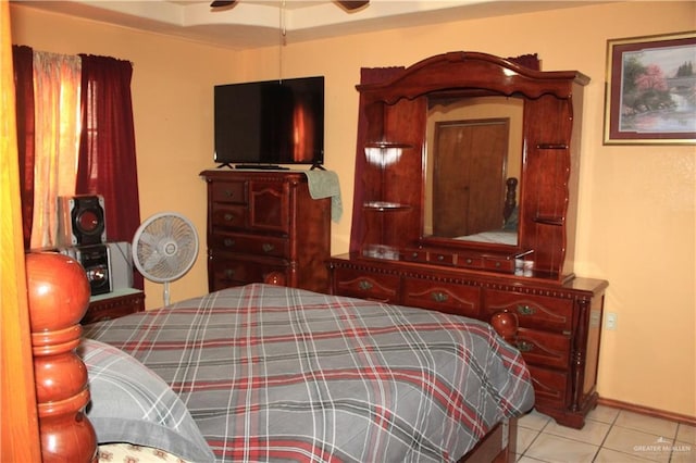 tiled bedroom featuring ceiling fan