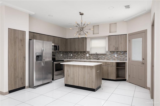 kitchen featuring visible vents, modern cabinets, appliances with stainless steel finishes, a center island, and light countertops