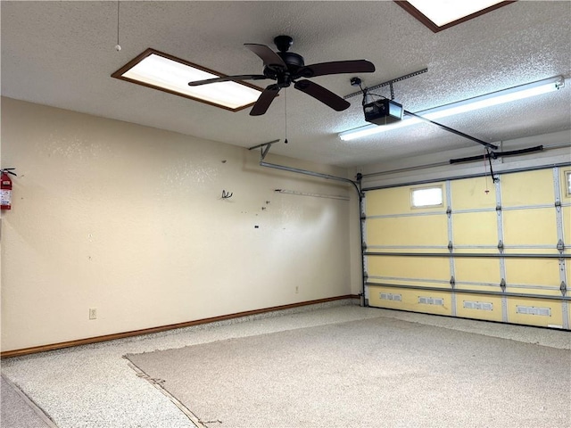 garage featuring a garage door opener and baseboards