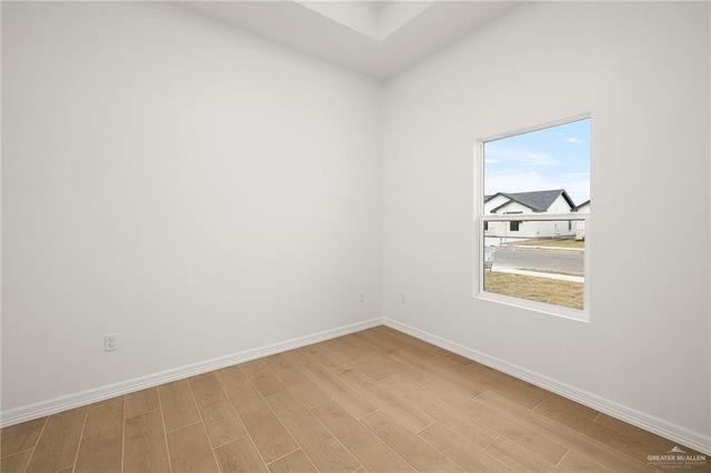 unfurnished room with light wood-type flooring