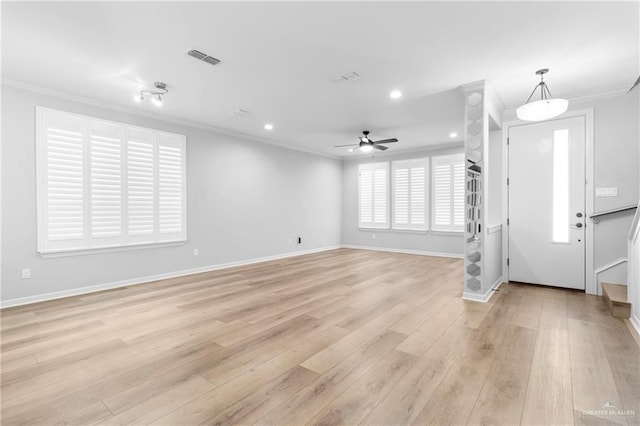 foyer entrance with light wood-type flooring, ceiling fan, and crown molding