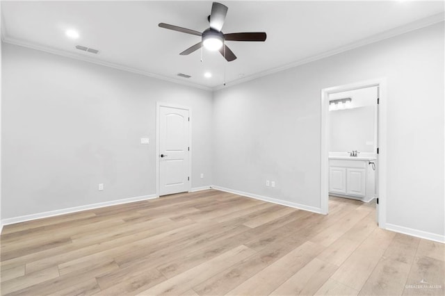 spare room featuring ceiling fan, sink, crown molding, and light wood-type flooring