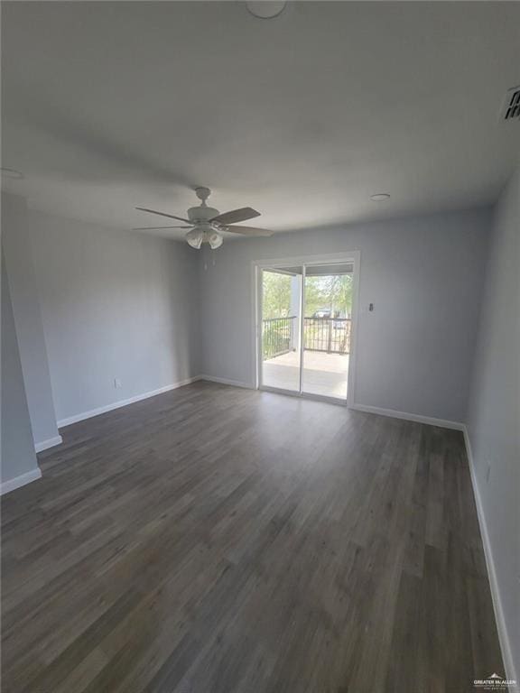 empty room featuring ceiling fan and dark hardwood / wood-style floors