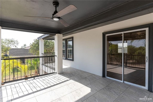 exterior space with ceiling fan and a balcony