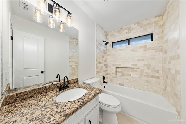 full bathroom with tiled shower / bath, vanity, and toilet