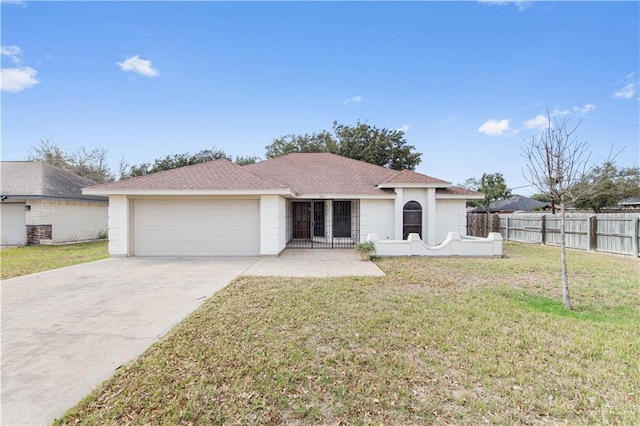 view of front of property featuring a garage and a front lawn