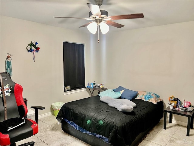 tiled bedroom featuring ceiling fan