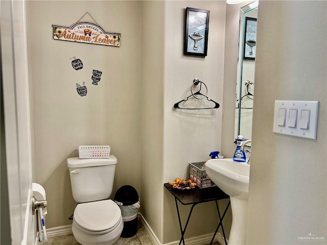 bathroom with tile patterned floors and toilet