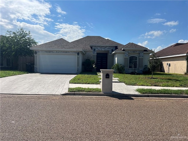 view of front of home with a front yard and a garage