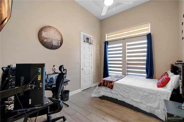 bedroom with ceiling fan and light hardwood / wood-style flooring