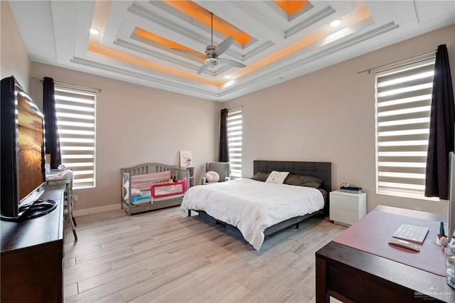 bedroom featuring multiple windows, ceiling fan, and light hardwood / wood-style flooring