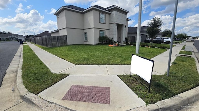 view of side of home with a yard