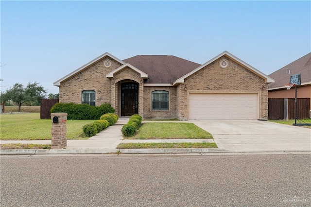 view of front of home with a front yard and a garage