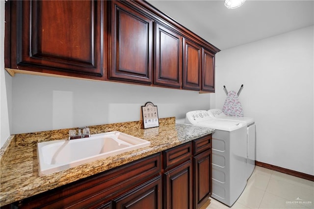 laundry room featuring separate washer and dryer, sink, cabinets, and light tile patterned flooring