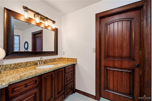 bathroom featuring tile patterned flooring and vanity