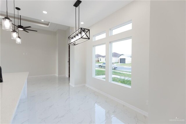 unfurnished dining area with ceiling fan