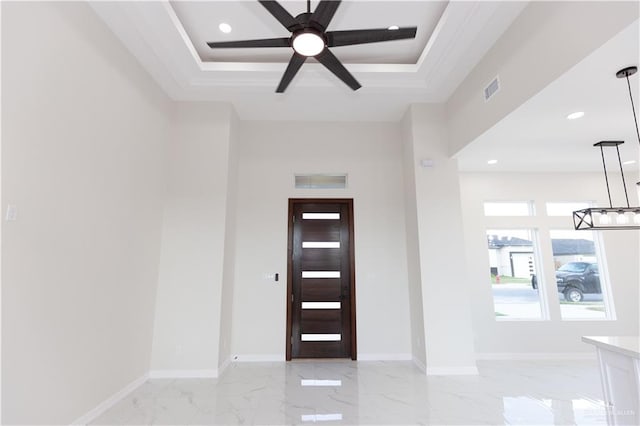 foyer entrance with a tray ceiling