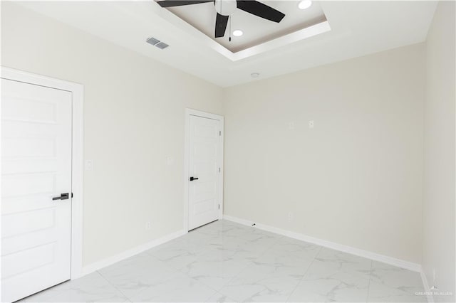 unfurnished room with a tray ceiling and ceiling fan