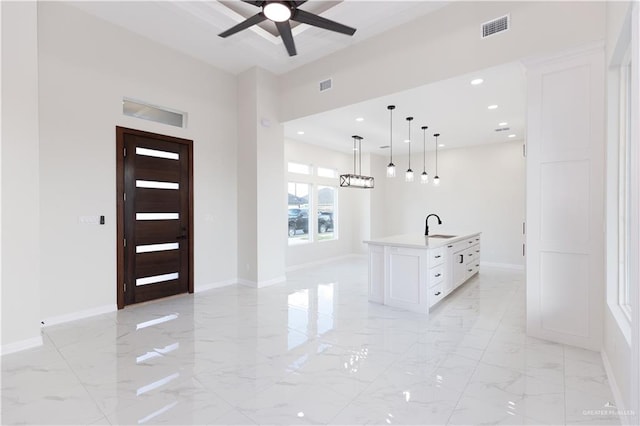 entrance foyer with ceiling fan and sink