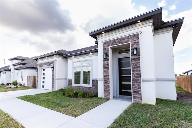 view of front of house with a front yard and a garage