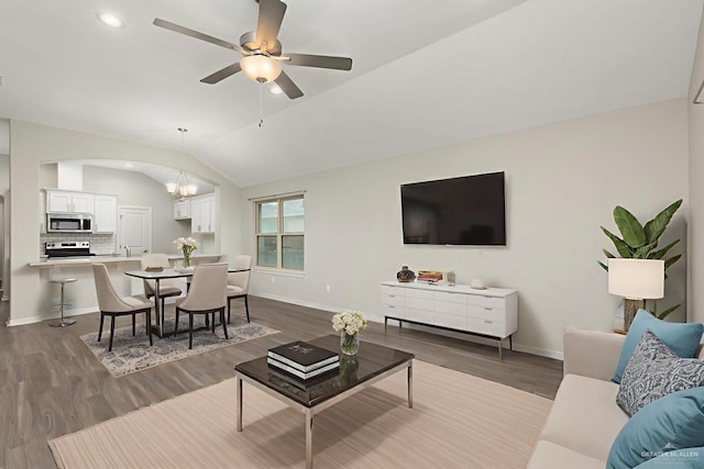 14222 Chalk Ridge Dr, Mcallen, TX 78504 - living room with vaulted ceiling, baseboards, dark wood-style flooring, ceiling fan, and arched walkways