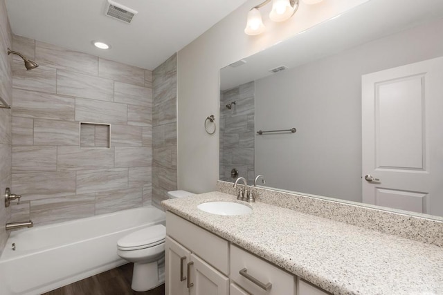 14222 Chalk Ridge Dr, Mcallen, TX 78504 - bathroom featuring toilet, vanity, washtub / shower combination, and wood finished floors