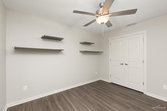 14222 Chalk Ridge Dr, Mcallen, TX 78504 - unfurnished bedroom with baseboards, dark wood-type flooring, ceiling fan, and a closet